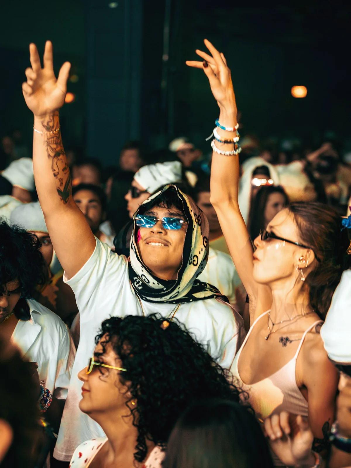 Crowd with hands raised as confetti falls at PURE 2025