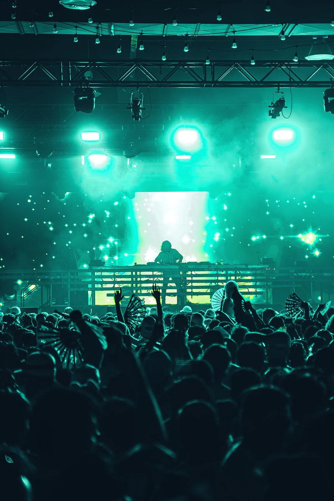 Green-lit stage and LED screen above the PURE 2024 crowd